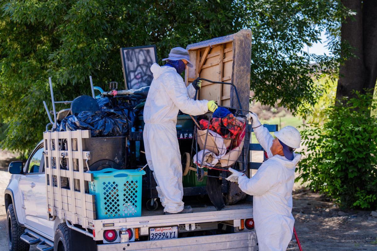 Cleanup crews load collected items onto a truck during a City of Riverside and Caltrans partnership effort.