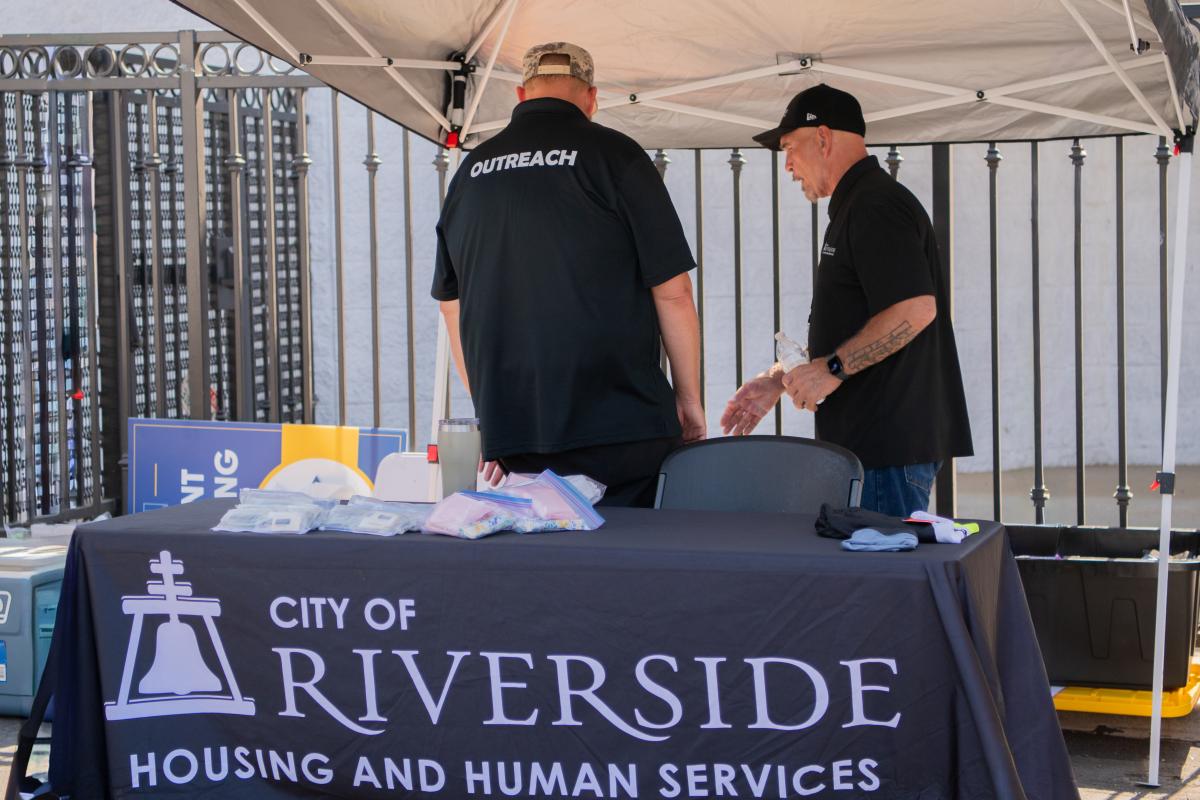 City of Riverside Housing and Human Services outreach staff preparing an outreach services table.