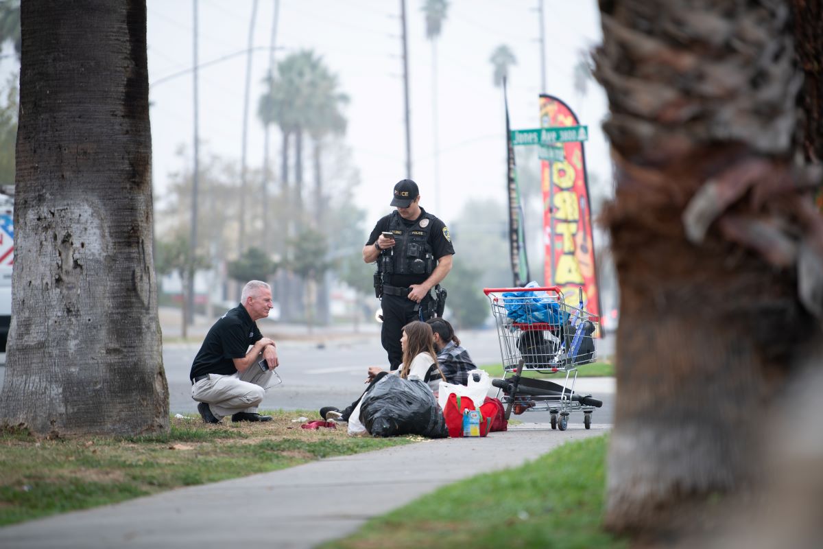 PSET team members speaking with residents along a Riverside sidewalk.