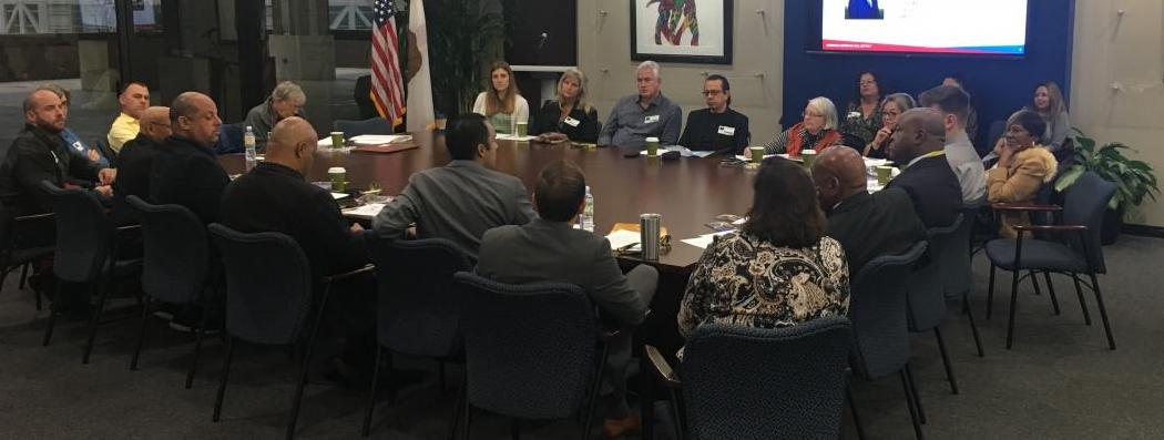 Photo of Dr. Angelov Farooq presenting to the Mayor's Multicultural Council