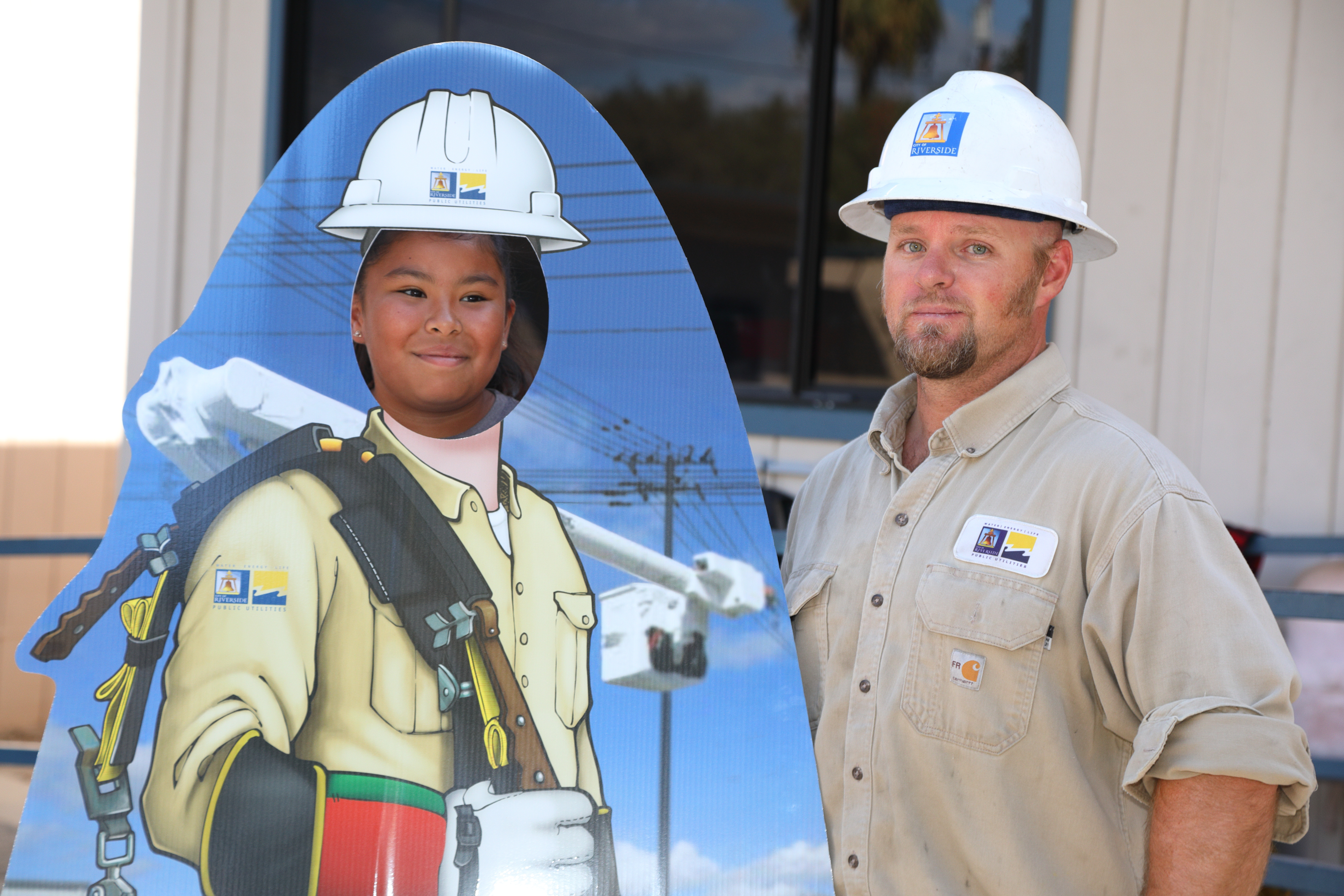 Utility professionals speaking with students during a career day event